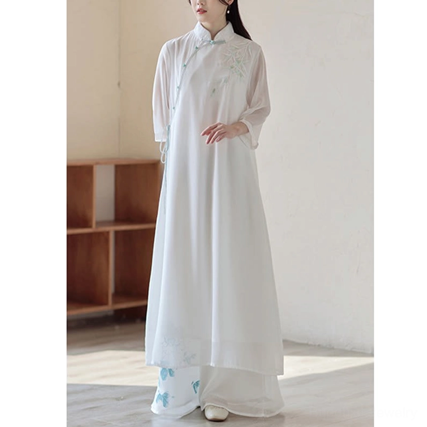 Spiritual practice wear cheongsam dress and wide leg pants, full-body front-side shot with relaxed standing pose showing blue floral prints on pants