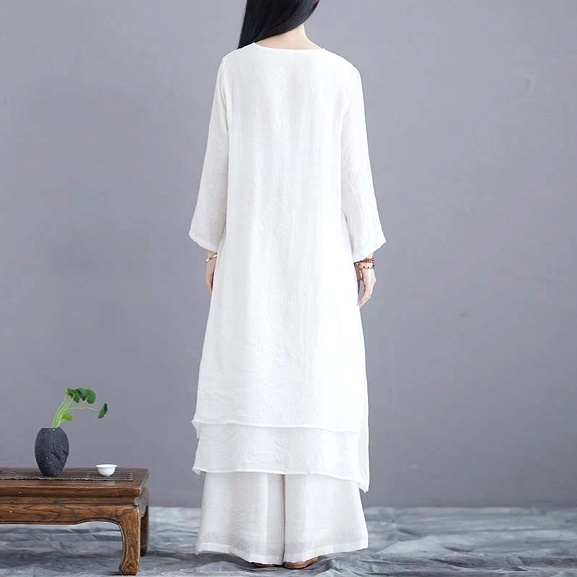 Back view of white zen meditation outfit showing layered hemline and wide-leg pants silhouette