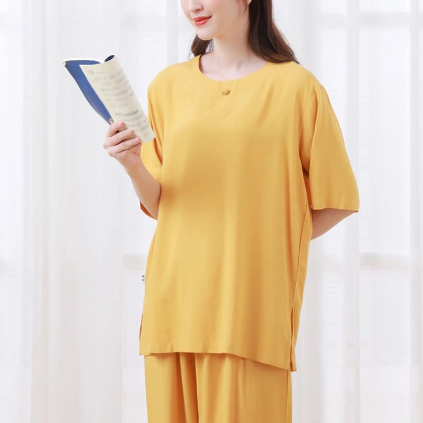 Yellow Zen meditation clothing front standing holding book mindfulness practice