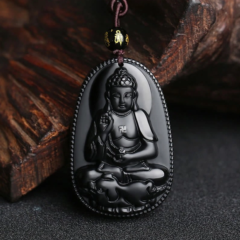 Black obsidian zodiac Buddha amulet pendant with oval shape and embossed spiritual carving