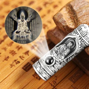 Chinese zodiac guardian Buddha projection necklace pendant with embossed relief and black gemstone, front view on bamboo background